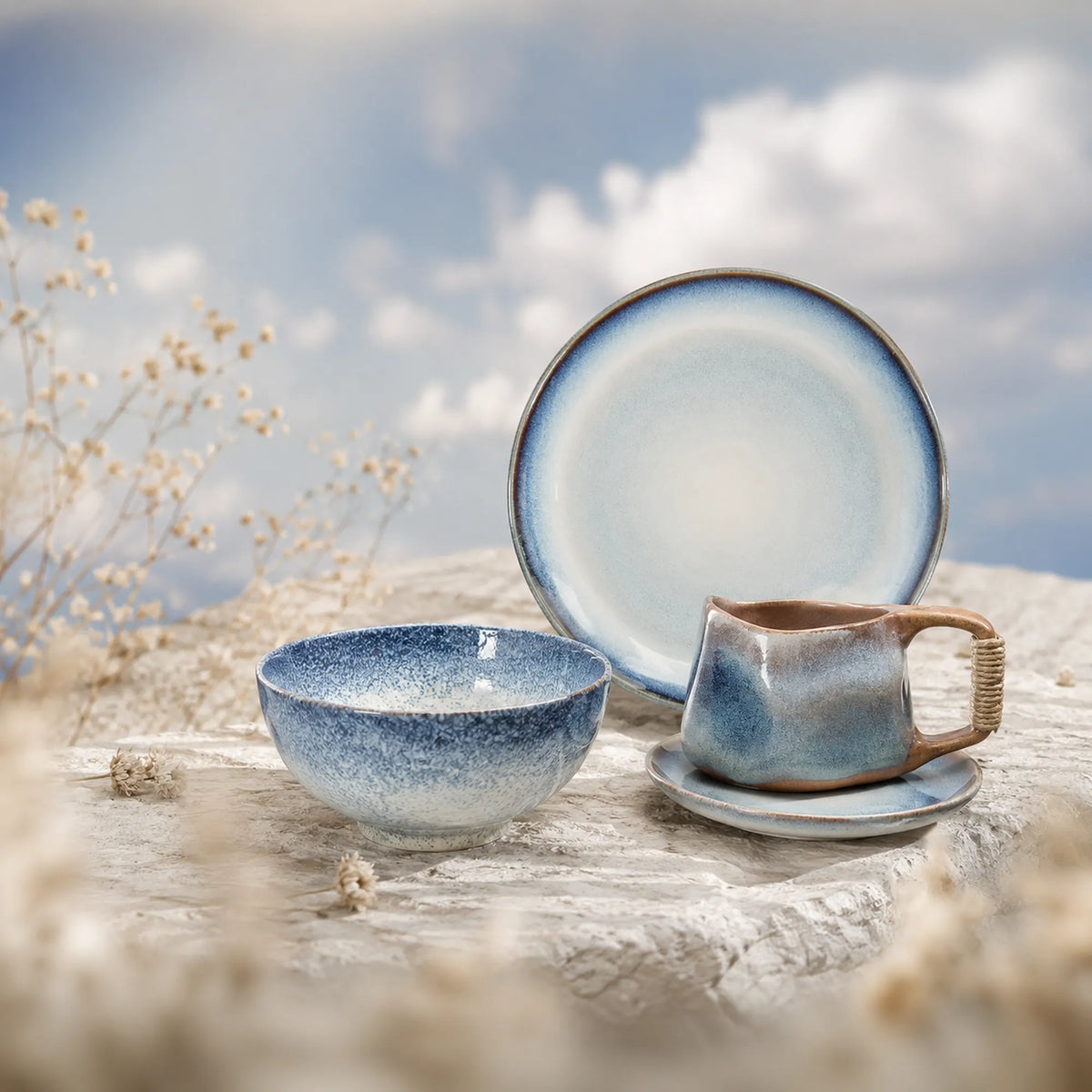 Sky ceramic dinnerware collection inspired by open skies and soft clouds, featuring blue ceramic plates, bowls and cups.