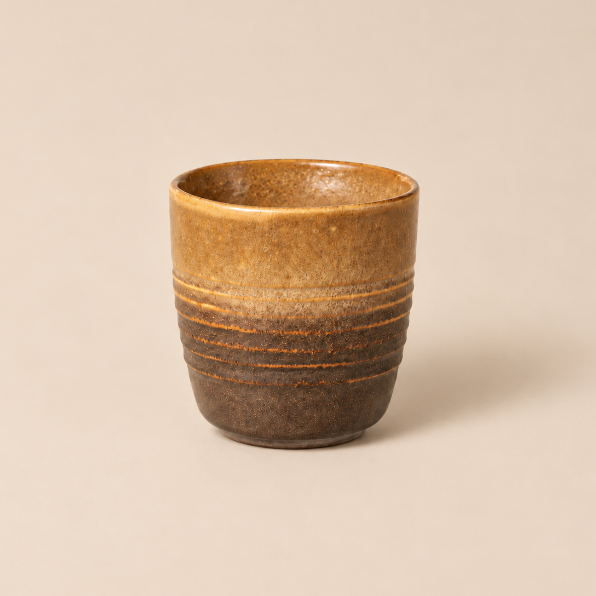 Earthy sand brown ceramic tea cup with sandstone glaze