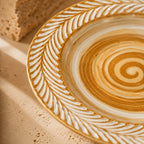Close-up spiral glaze detail of clay brown ceramic dinner plate
