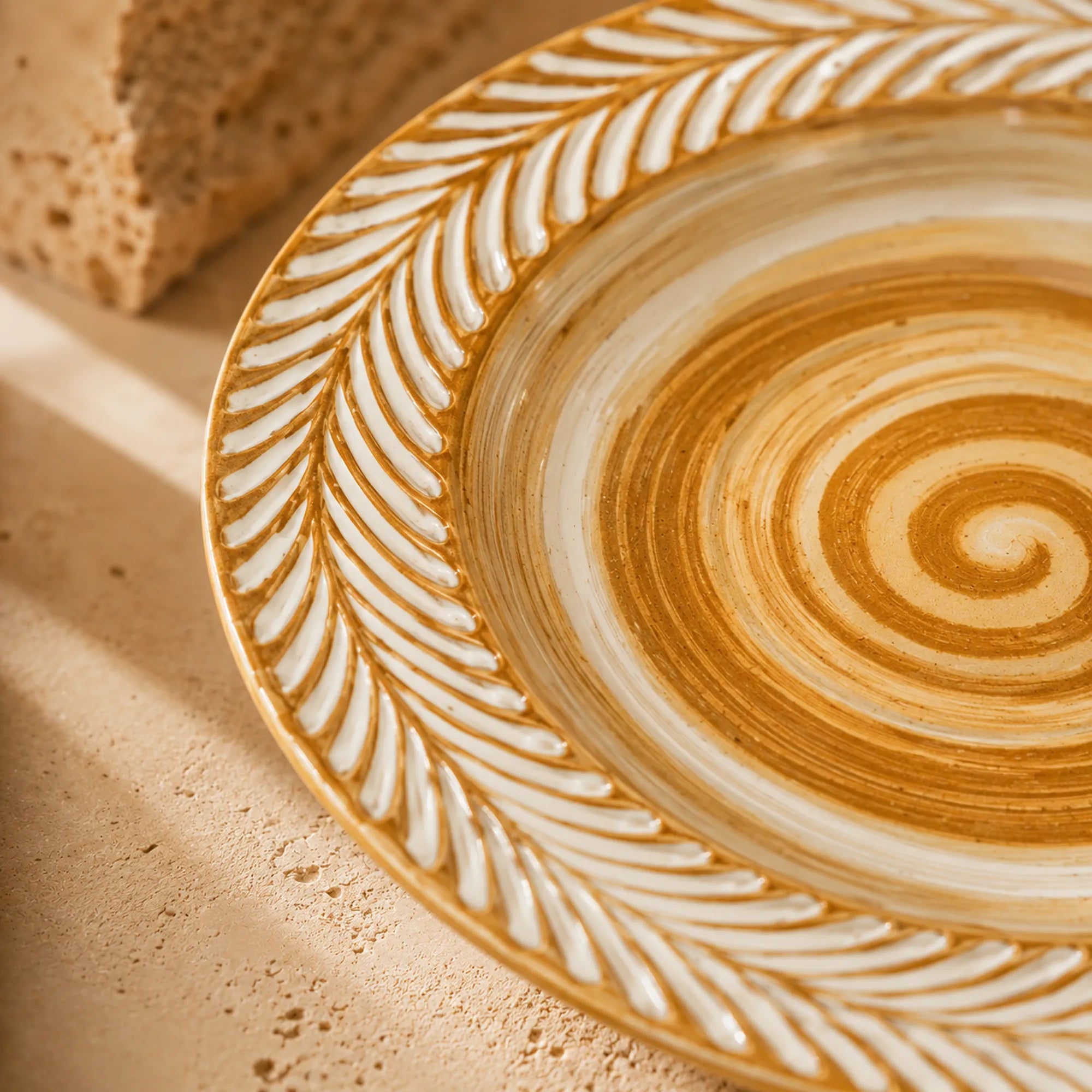 Close-up spiral glaze detail of clay brown ceramic dinner plate