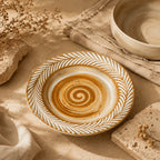Clay brown ceramic dinnerware styled on a rustic dining table