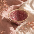 Coral pink ceramic dessert bowl styled on a minimalist table