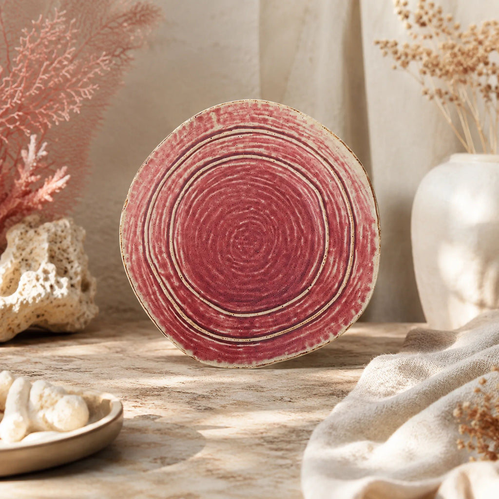 Vibrant coral pink ceramic dinner plate with glossy glaze finish