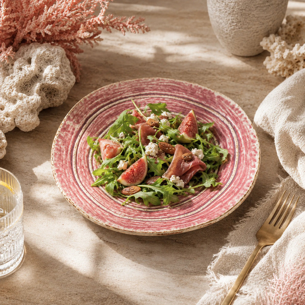 Coral pink ceramic dinner plate styled with fresh cuisine