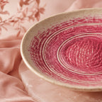 Close-up glaze detail of coral pink ceramic pasta bowl