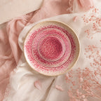 Coral pink ceramic pasta bowl styled in a modern dining setting