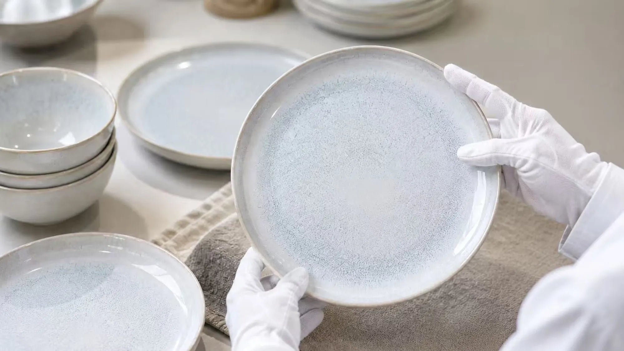 Ceramic dinnerware undergoing detailed quality inspection before packaging