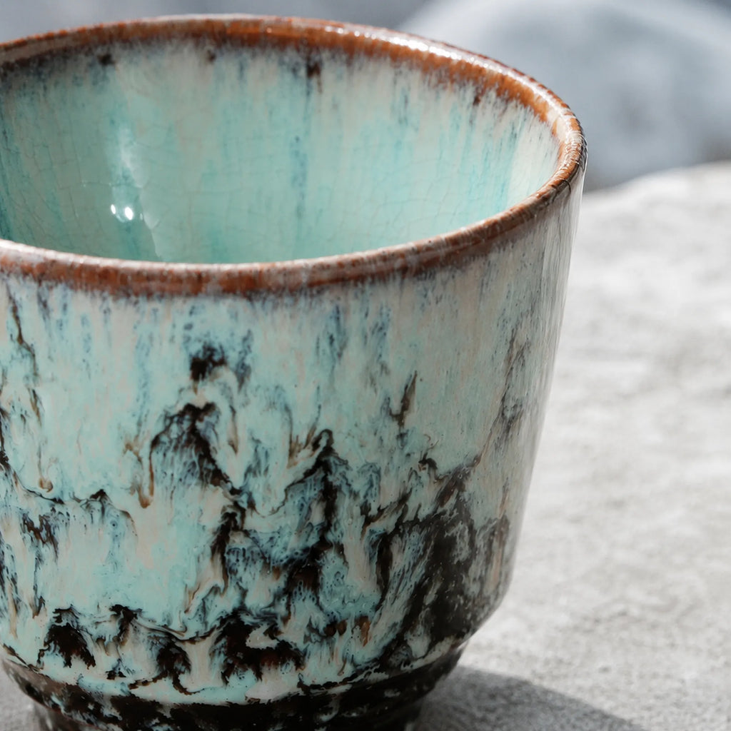 Close-up crackle glaze detail of ice blue ceramic tea cup