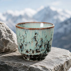 Ice blue ceramic tea cup styled in a soft tea setting