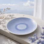 Mist blue ceramic dinnerware styled on a natural dining table