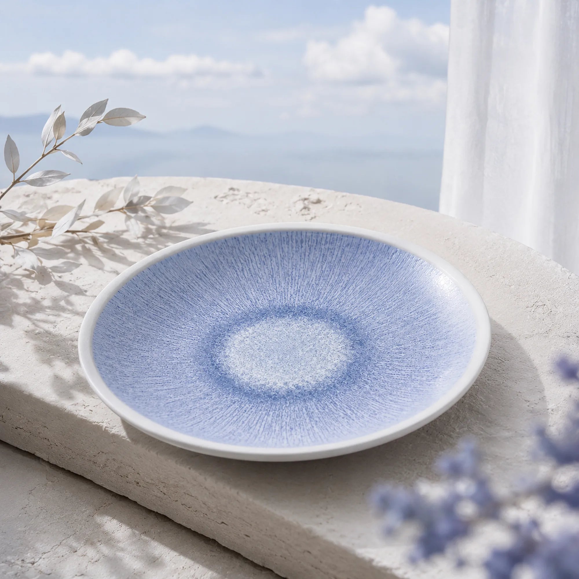 Mist blue ceramic dinnerware styled on a natural dining table