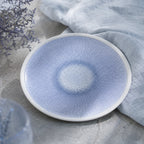 Mist blue ceramic dinnerware styled on a natural dining table