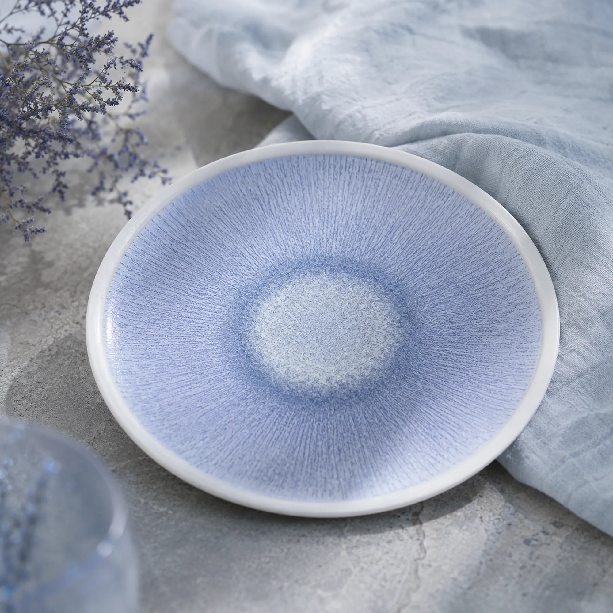 Mist blue ceramic dinnerware styled on a natural dining table