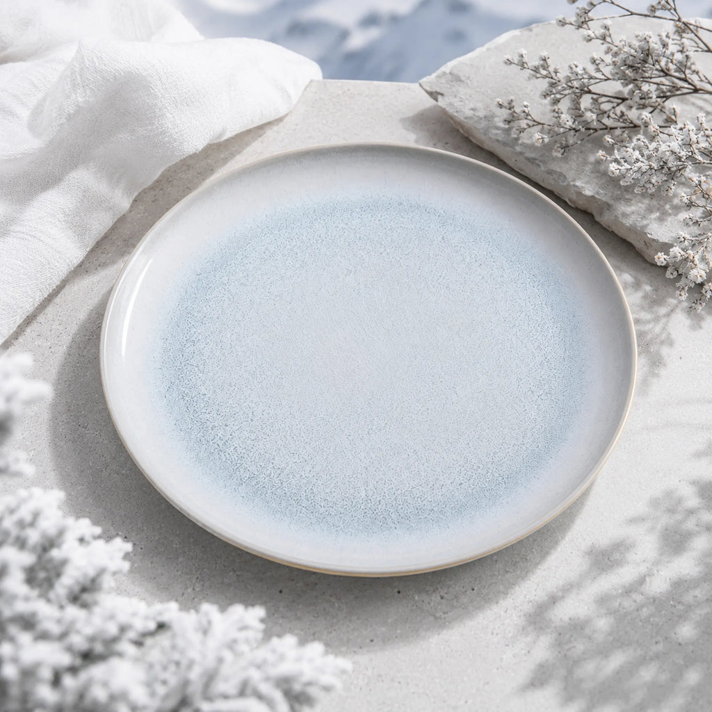 Mist blue ceramic dinnerware styled on a natural dining table