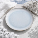Mist blue ceramic dinnerware styled on a natural dining table