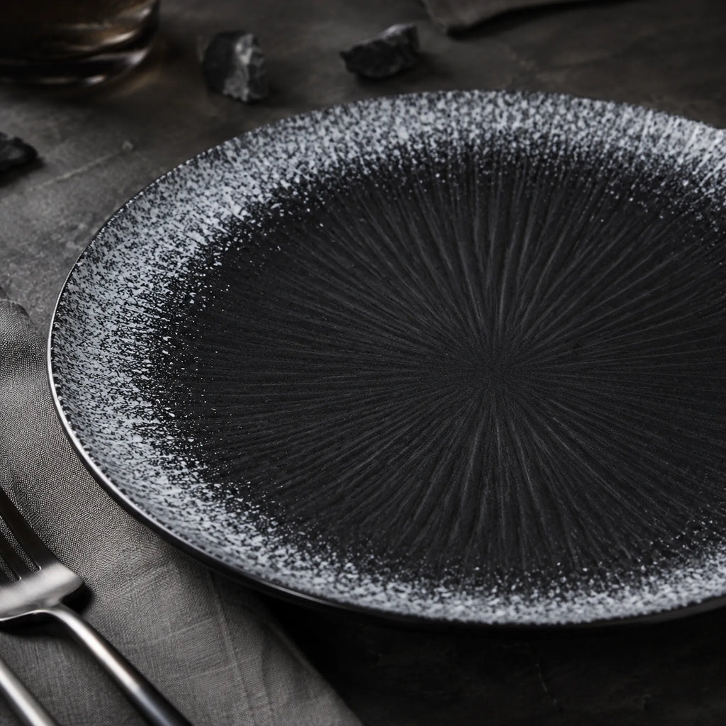 Close-up matte texture of obsidian black ceramic dinner plate