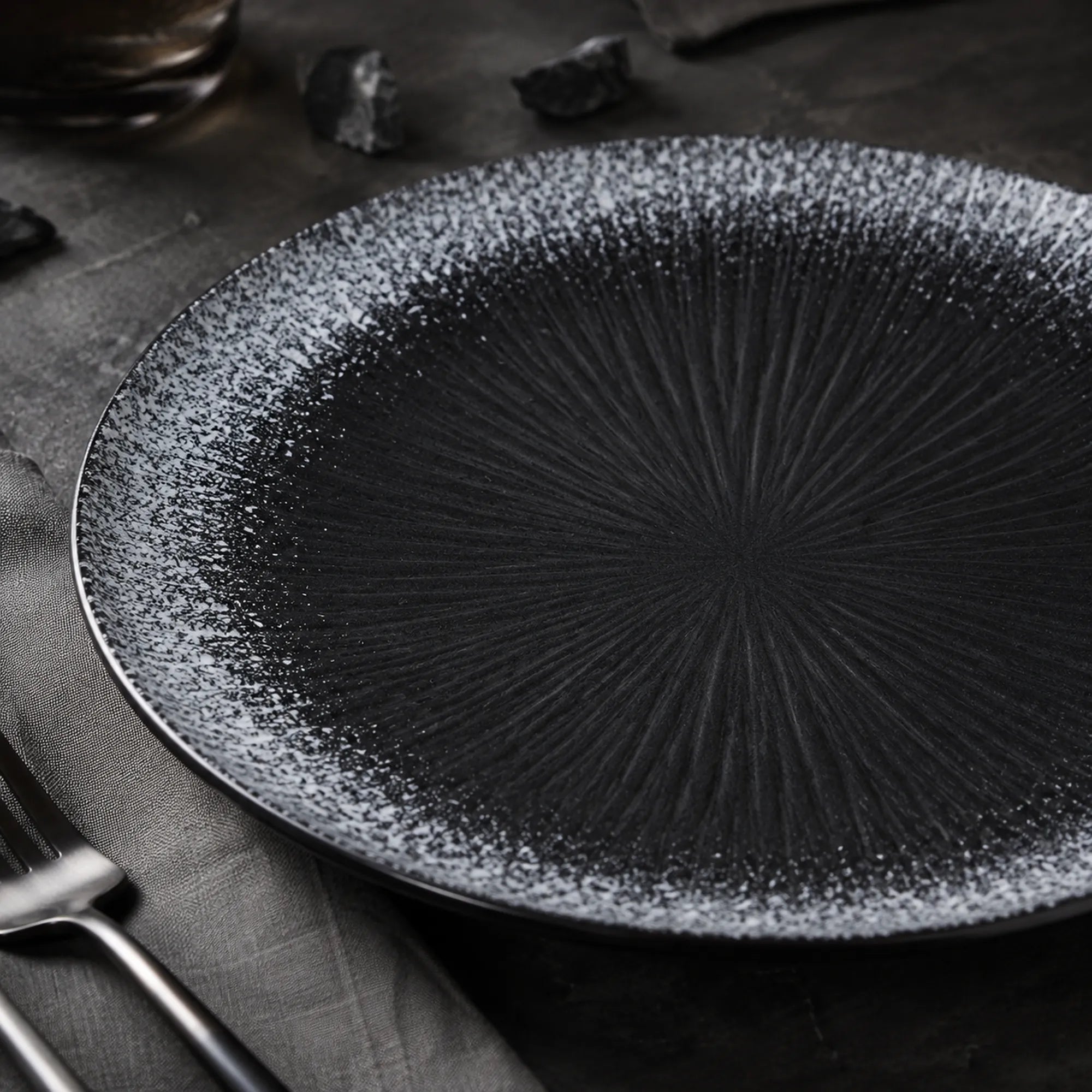 Close-up matte texture of obsidian black ceramic dinner plate