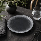 Obsidian black ceramic dinnerware styled on a moody dining table