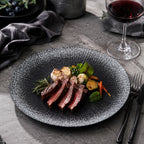 Obsidian black ceramic dinner plate styled with gourmet food