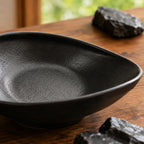 Close-up ceramic texture of obsidian black oval plate