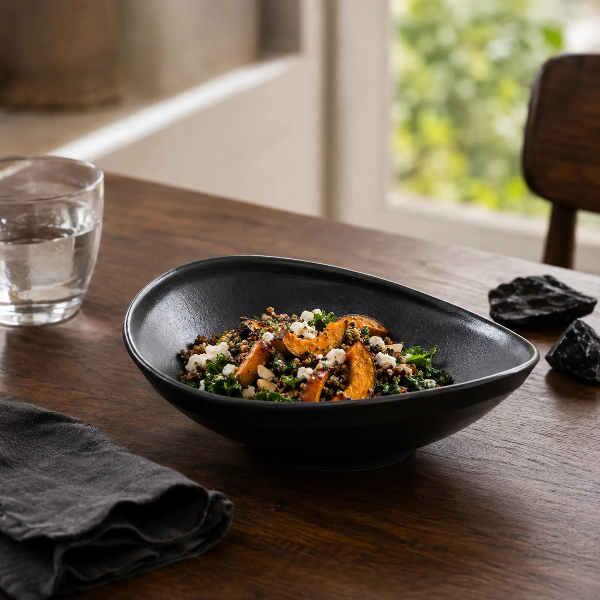 Obsidian black ceramic oval plate styled with plated cuisine