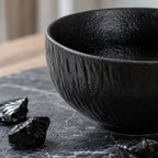 Close-up matte ceramic texture of obsidian black rice bowl