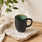 Peacock green ceramic coffee mug with textured glaze