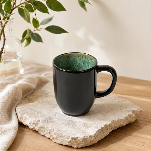 Peacock green ceramic coffee mug with textured glaze