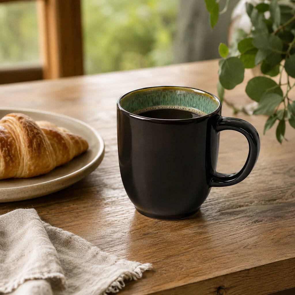 Peacock green ceramic coffee mug styled with coffee