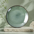 Peacock green ceramic dinner plate with textured glaze