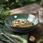 Peacock green ceramic pasta bowl styled with pasta