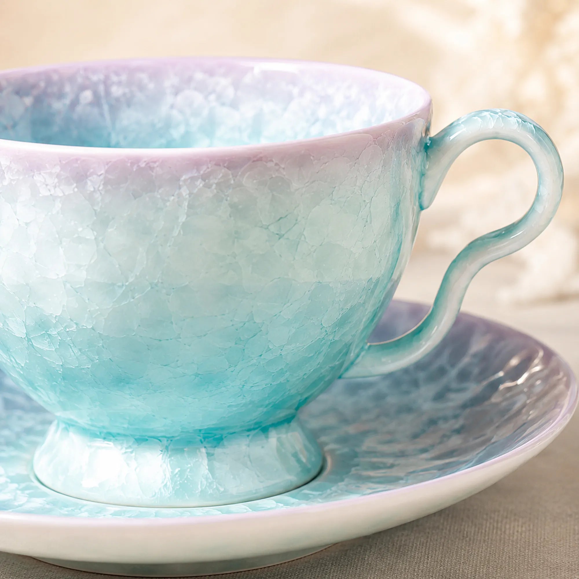 Close-up glaze detail of pearl blue ceramic coffee cup set