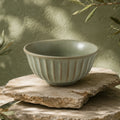 Organic sage green ceramic rice bowl with textured glaze