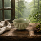 Sage green ceramic rice bowl styled on a dining table