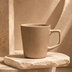 Warm sand beige ceramic coffee mug with smooth glazed finish