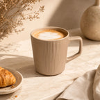 Sand beige ceramic coffee mug served with coffee