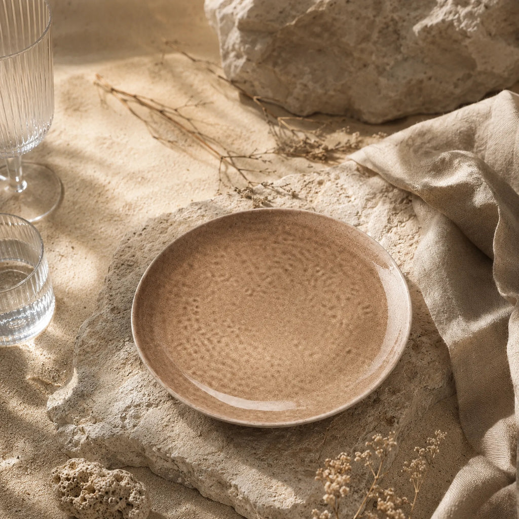 Sand beige ceramic dinnerware styled on a warm dining table