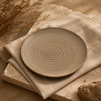Sand brown ceramic dinnerware styled on a natural dining table