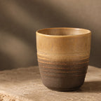 Close-up glaze detail of sand brown ceramic tea cup
