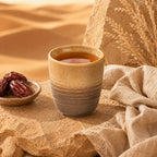 Sand brown ceramic tea cup served with tea