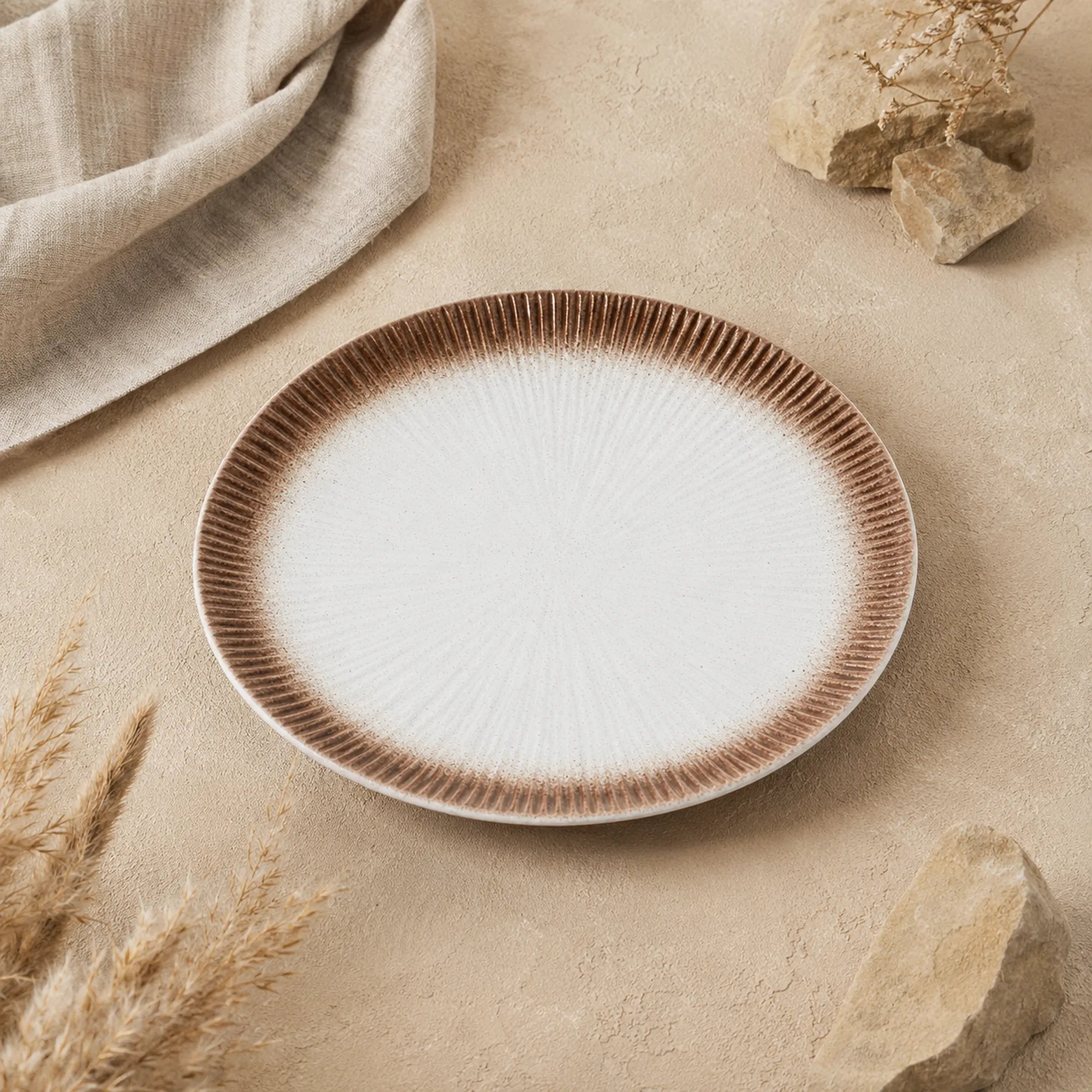 Sand white ceramic dinnerware styled in a minimalist dining setting