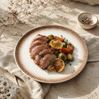 Sand white ceramic dinner plate styled with fresh cuisine