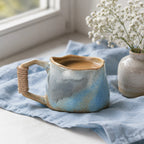 Soft blue ceramic coffee mug styled on a modern coffee table