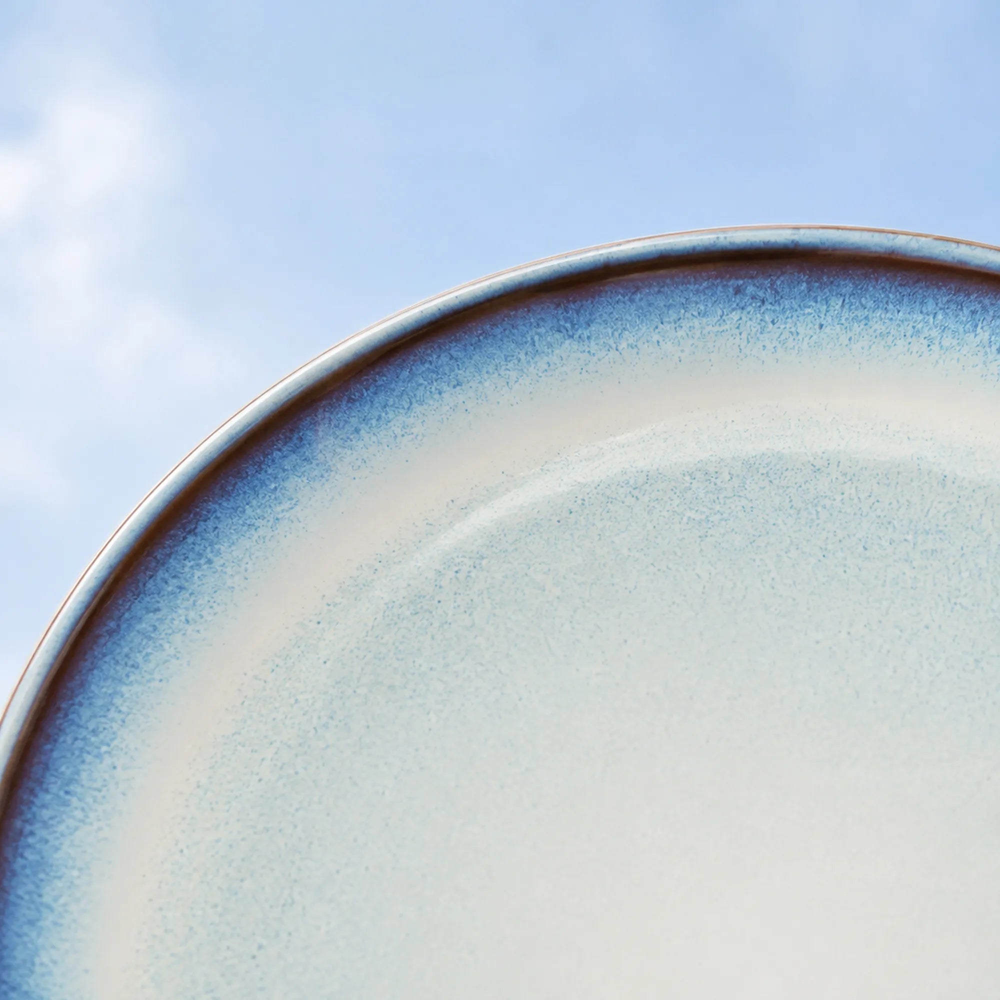 Close-up glaze detail of airy sky blue ceramic dinner plate