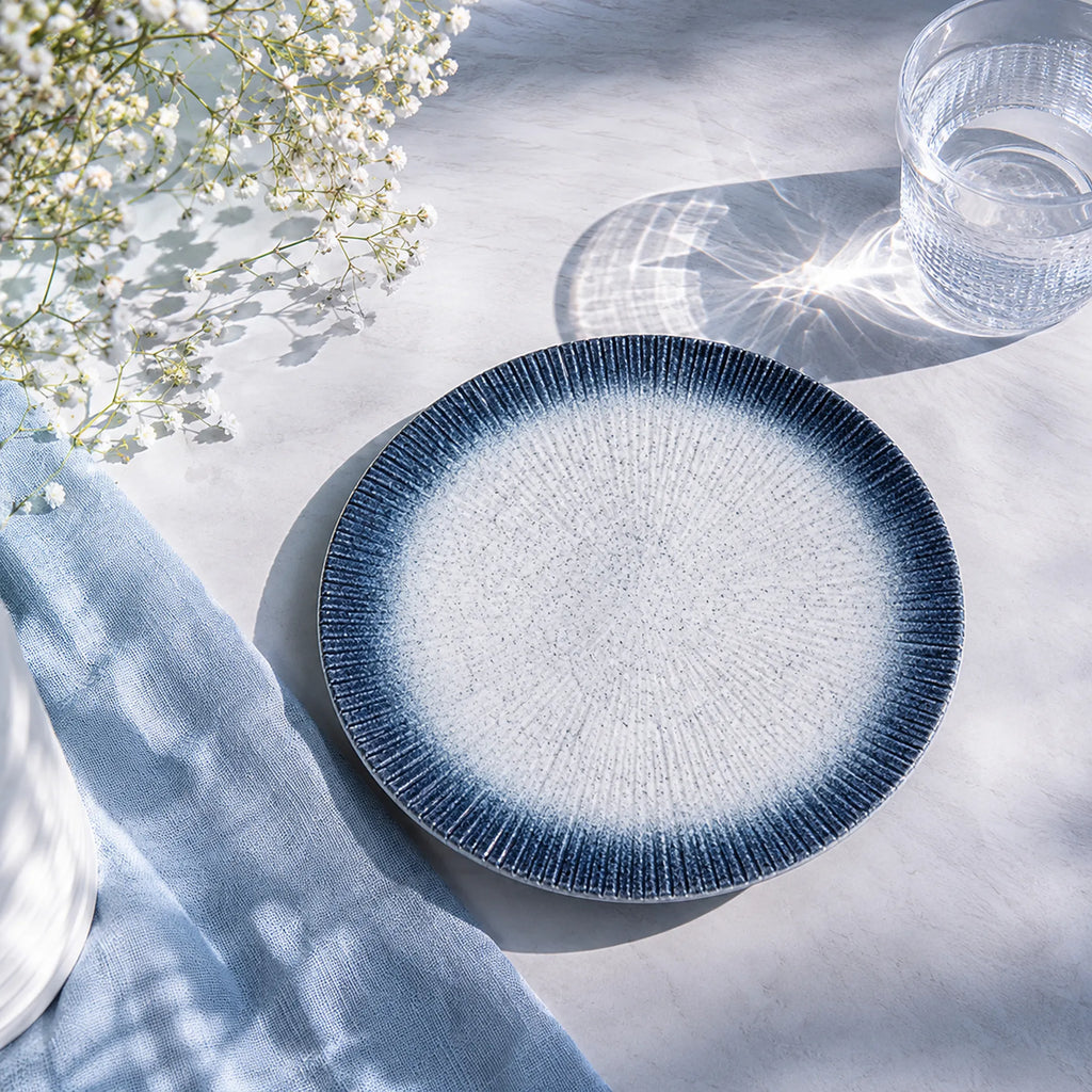 Sky blue ceramic dinnerware styled in a calm dining setting