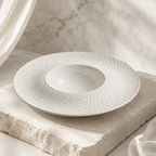 Snow white ceramic pasta plate styled in a calm dining setting