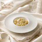 Snow white ceramic pasta plate styled with pasta
